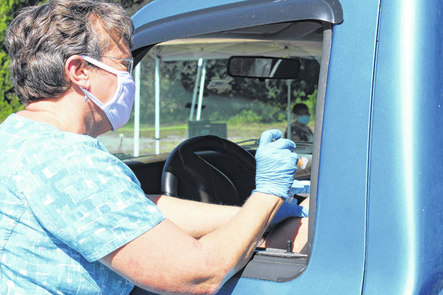 
			
				                                Anson County Health Department nurses greet patients at their car windows to give them flu vaccines on Sept. 30.
                                 Liz O’Connell | Anson Record

			
		