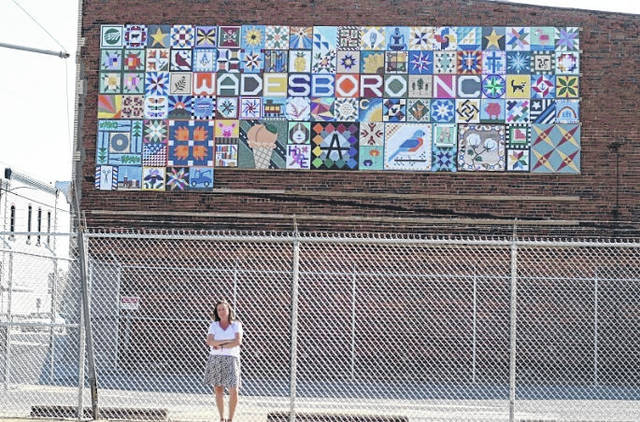 
			
				                                Mural project organizer Elizabeth Schafer Oliver hopefully awaits to put back together the community mural after deciding it was not fit to be placed next to a fenced off parking lot. 
                                 Contributed Photo by Amanda Prouty. 

			
		