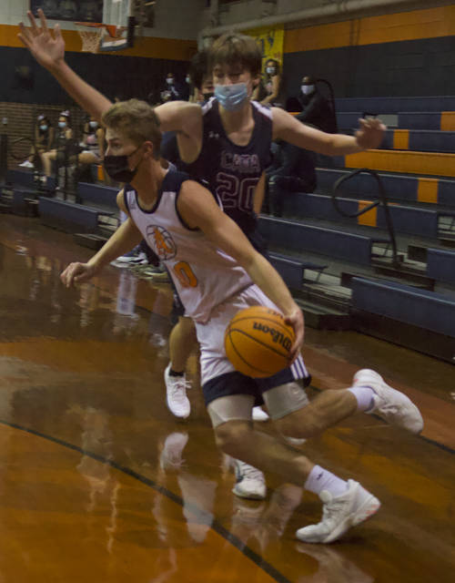 Senior Sam Ingram dribbles the ball towards the basket beating a CATA defender during the game on Jan. 22. Ingram had 12 points, seven rebounds, three assists and two steals.
Liz O’Connell | Anson Record