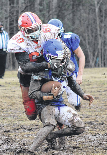 Anson defense plows through offensive line to tackle the Albemarle quarterback during a scrimmage on Feb. 19.
                                 Liz O’Connell | Anson Record