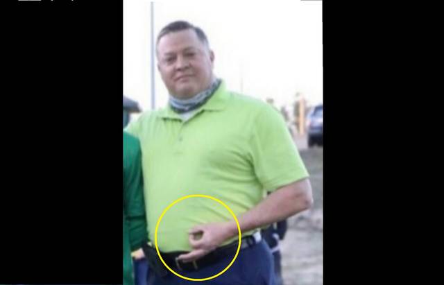 
			
				                                Contributed photo
                                Officer Thomas Luckey holds up an “OK” sign during a photo at his son’s senior night ceremony. This symbol is considered a hate symbol by the Anti-Defamation League.
 
			
		