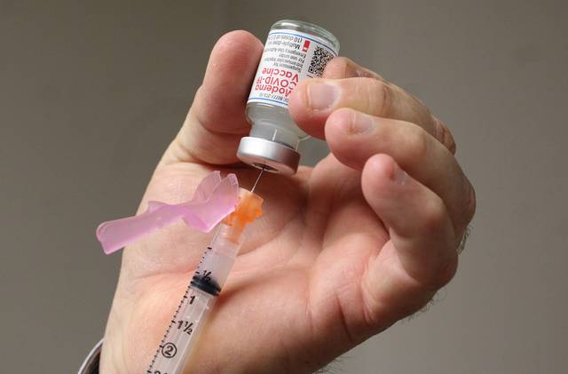 
			
				                                Anson Record file photo
                                Dwayne Miller, FirstHealth’s pharmacy director and vaccine coordinator, holds a dose of Moderna’s COVID-19 vaccine on the first day it was being administered to hospital staff, Dec. 23, 2020.
 
			
		