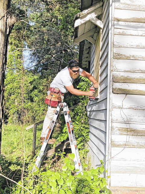 
			
				                                Peachland resident Austin Kirkland secures windows on the historic birthplace of L.L. Polk. Kirkland and his wife Meagan plan on purchasing the house from Preserve Mecklenburg.
                                 Contributed Photo

			
		