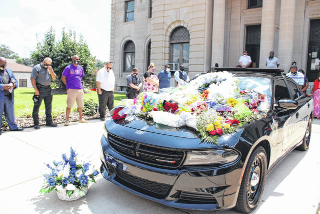 
			
				                                Gavin Stone | Daily Journal
                                Well wishers placed flowers on the hood of a Sheriff’s Office cruiser parked in front of the Courthouse in honor of the passing of Sheriff James Clemmons.
 
			
		