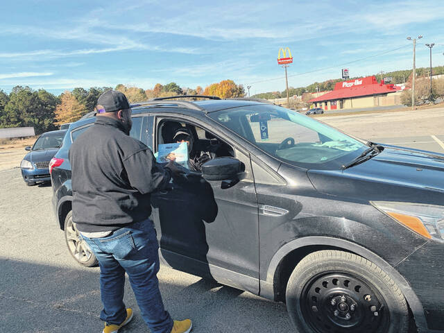 
			
				                                A volunteer hands out a food box and eggs.
                                 Hannah Barron | Anson Record

			
		