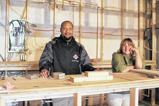 
			
				                                Garrett Snuggs and his general manager Amanda Lambert pose during construction of their new bar and grill, set to open in February.
                                 Contributed photo

			
		