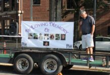 
			
				                                Commissioner Jason Gainey bows his head in prayer. “I want to step aside for a minute and I want you to take a look at the banner behind me, this is far more important than who I am or who I represent. These are our friends and loved ones and family members that have been affected by drugs.”
 
			
		